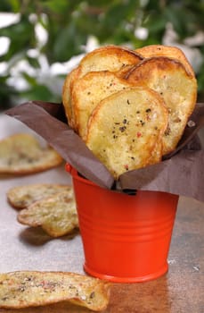 Homemade potato chips wrapped in paper and folded  bucket