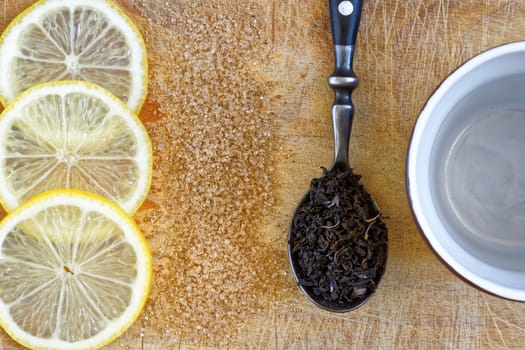 ingredients for tea, lemon, brown sugar, mug
