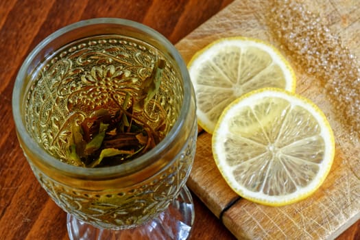 green tea in glass, lemon, brown sugar