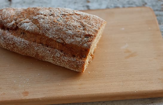 Fresh bread slice on a rustic table