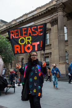 Protesters rally against the torture and detention of indigenous children in the Northern Territory. The rally was held outside the State Library.