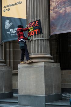 Protesters rally against the torture and detention of indigenous children in the Northern Territory. The rally was held outside the State Library.