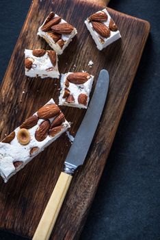 Traditional italina nougat with almonds on wooden rustic board