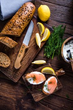 Healthy brunch smoked salmon with cottage cheese on wooden rustic board