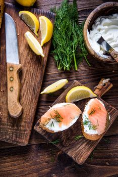 Fresh bread with smoked salmon in rustic kitchen