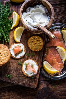 Healthy brunch smoked salmon with cottage cheese on wooden rustic board