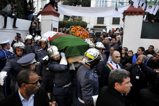 ALGERIA, Algiers : Algerians pay tribute to late Algerian opposition figure Hocine Ait-Ahmed, on December 31, 2015 in the capital Algiers after his body was brought to his homeland for a state funeral. Ait-Ahmed, one of the fathers of Algeria's struggle for independence from France and then a longtime opposition figure, died in Lausanne, Switzerland on December 23, his Socialist Forces Front party said. Ait-Ahmed, 89, was the last of the nine so-called sons of Toussaint, who launched the uprising in November 1954.