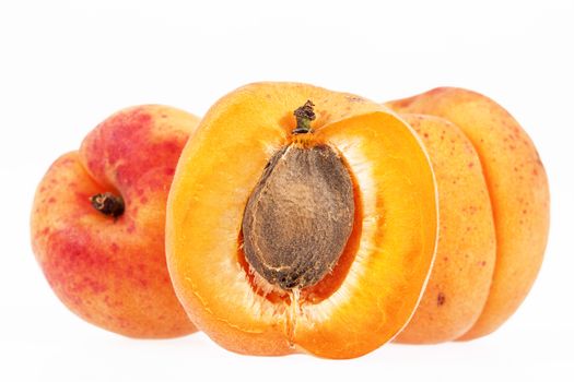 Whole and cut fruits of apricot isolated on white background, close up