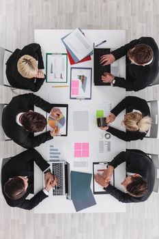 Business people discussing the charts and graphs showing the results of their successful teamwork