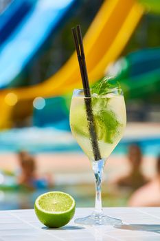 Close up Cocktail margaritas with lime near the swimming pool in hotel