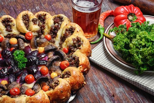 Delicious homemade steak pie with vegetables and plum jam in rustic style