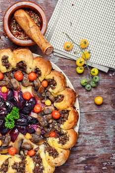 Delicious homemade steak pie with vegetables and plum jam in rustic style