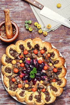 Delicious homemade steak pie with vegetables and plum jam in rustic style