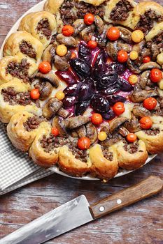 Delicious homemade steak pie with vegetables and plum jam in rustic style