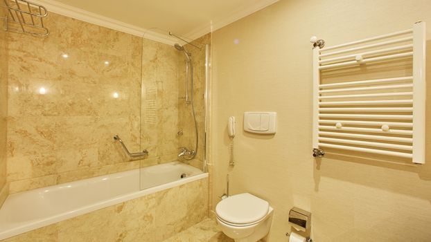 Luxury bathroom with mirrors, sink, shower and toilet.