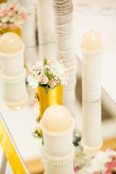 Wedding table decoration with candle, flowers and glassware