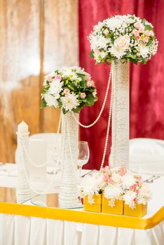 Wedding table decoration with flowers and glassware