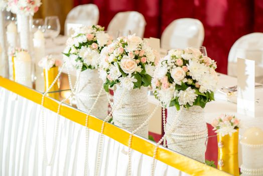 Wedding table decoration with flowers and glassware