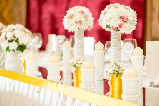 Wedding table decoration with flowers, candle and glassware