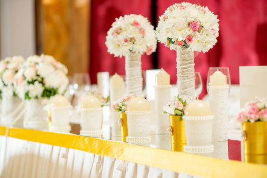 Wedding table decoration with candle, flowers and glassware