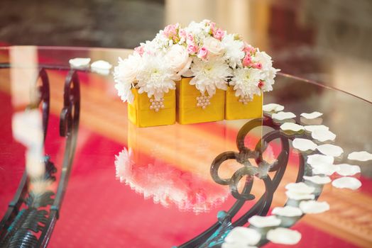 Wedding table decoration with white petals and flowers. Selective focus. 