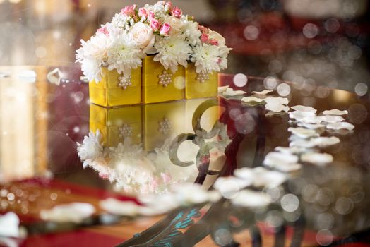 Wedding table decoration with white flowers and petals. 