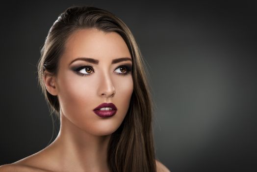 Portrait of a beautiful young brunette woman with perfect make-up