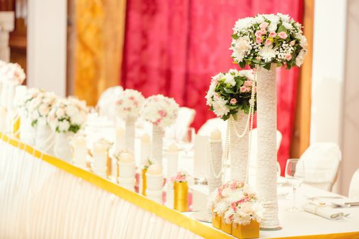 Wedding table decoration with flowers and glassware