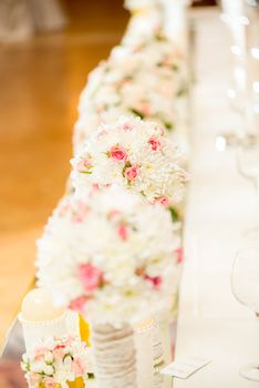 Wedding table decoration with flowers and glassware