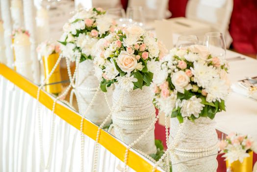 Wedding table decoration with flowers and glassware