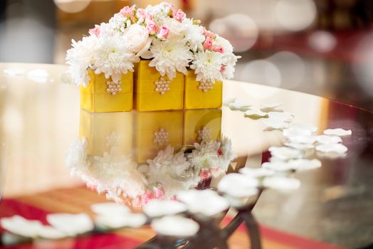 Wedding table decoration with white petals and flowers. Selective focus. 