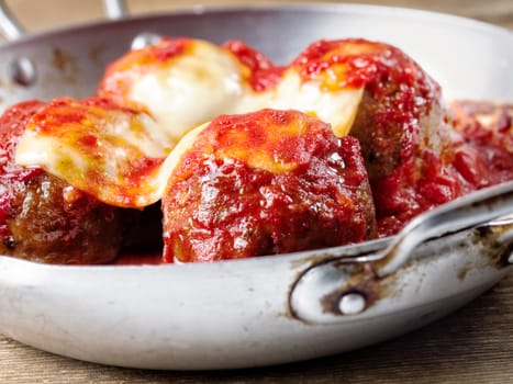 close up of                     traditional classic italian meatball in tomato sauce