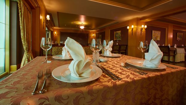 Empty wine glasses set in restaurant. Wide angle