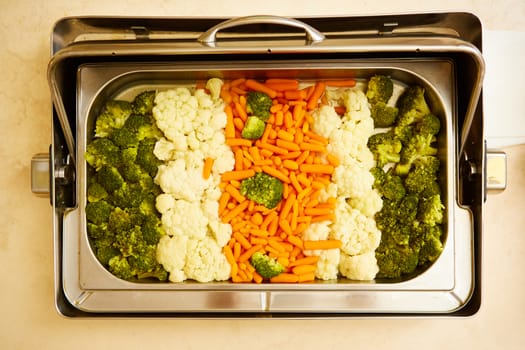 steamed vegetables in a dining room at breakfast in the hotel.