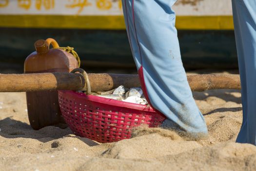 Pondichery, Tamil Nadu, India - February 27, 2014 : Traditional fishermen on beach, on sea, on sand. Long boats, Hard work poor people