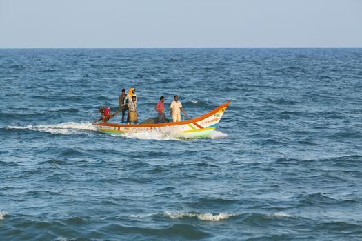 Pondichery, Tamil Nadu, India - February 27, 2014 : Traditional fishermen on beach, on sea, on sand. Long boats, Hard work poor people