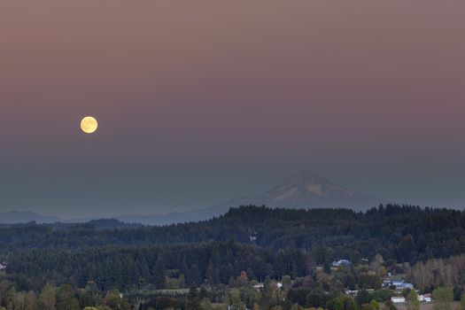 Full moon rising over Mt Hood after sunset in Happy Valley Oregon