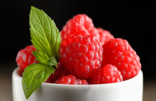 Ripe sweet raspberries in bowl