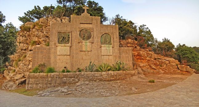 Lluc, Majorca, Spain - June 23, 2008: Monument near monastery Santuari de Santa Maria de Lluc - panorama - Serra de Tramuntana