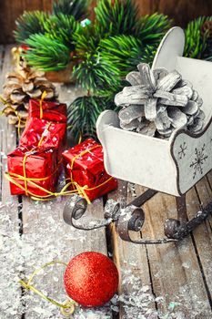 Christmas tree with pine cones,decorative sleigh, and decorations