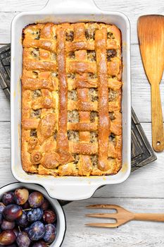 Baked according to traditional recipe meat pie with plums