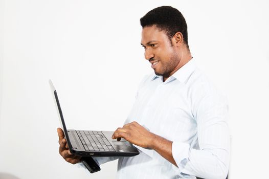 This young man feels more confortable working standing with his laptop in hand.
