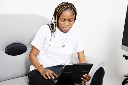 This young woman loves studying  with her laptop.