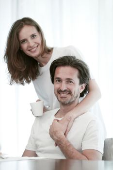 Portrait of happy couple embracing on white background