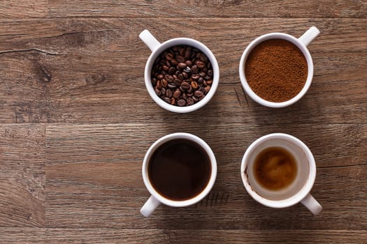  Four cups of coffee, phases of drink - bean, ground and empty cup