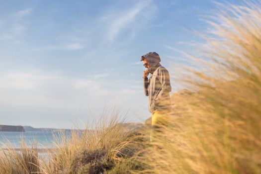 Sporty active man looking at distance, enjoying beautiful nature, freedom and life at serene landscape at Balos beach. Active lifestyle outdoors.