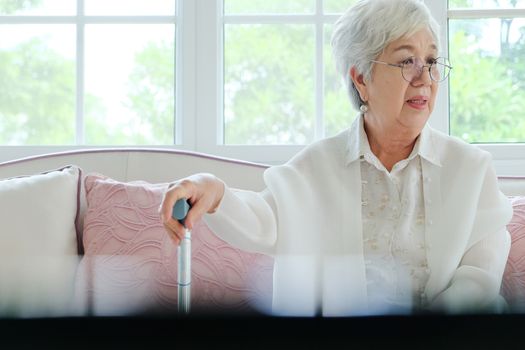 Retired woman with her walking stick