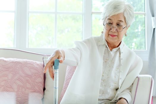 Retired woman with her walking stick