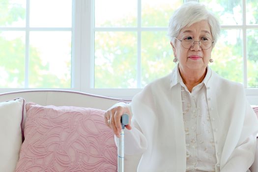 Retired woman with her walking stick