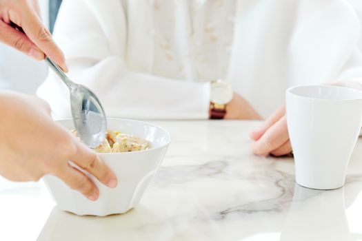 carer bringing meal to senior,meal time